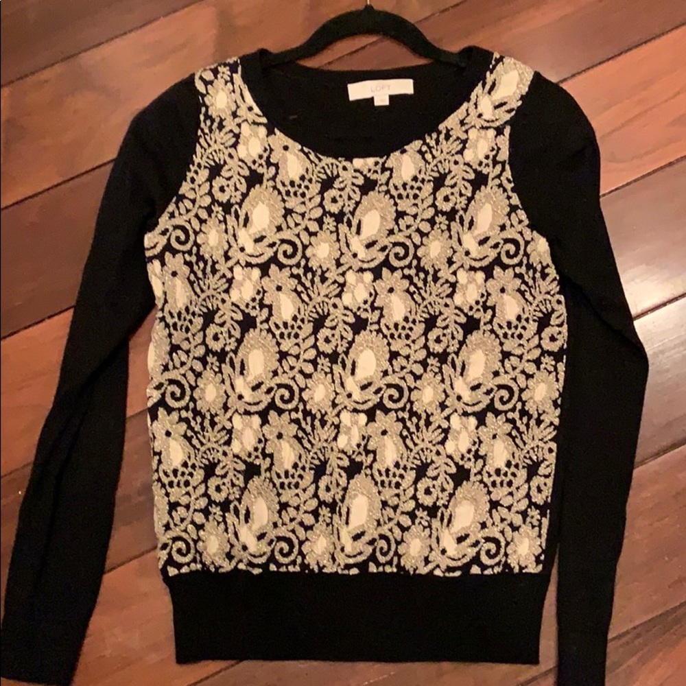Black sweater with gold detailing.